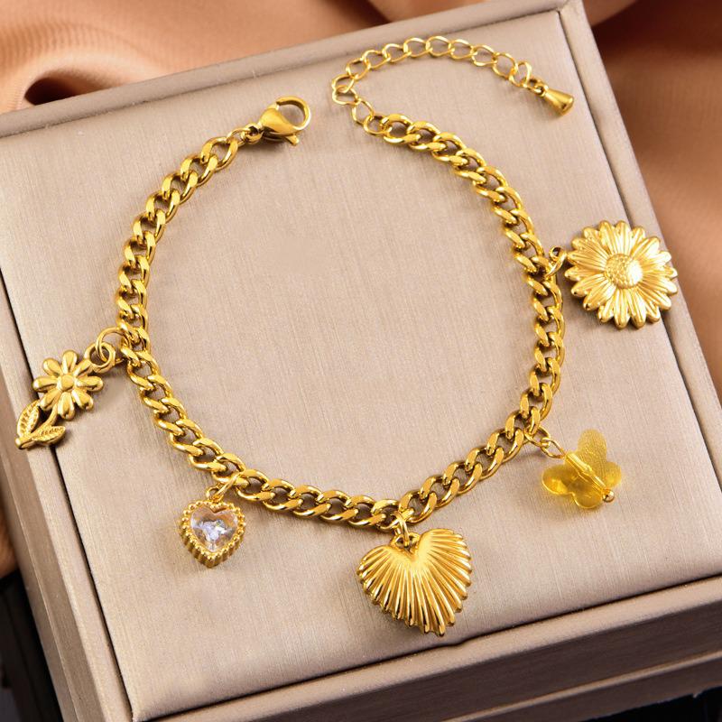 A bold gold bracelet featuring a sculpted bow charm and crystal accent. Feminine yet striking, this piece is made to stand out on its own or layered with delicate chains.
